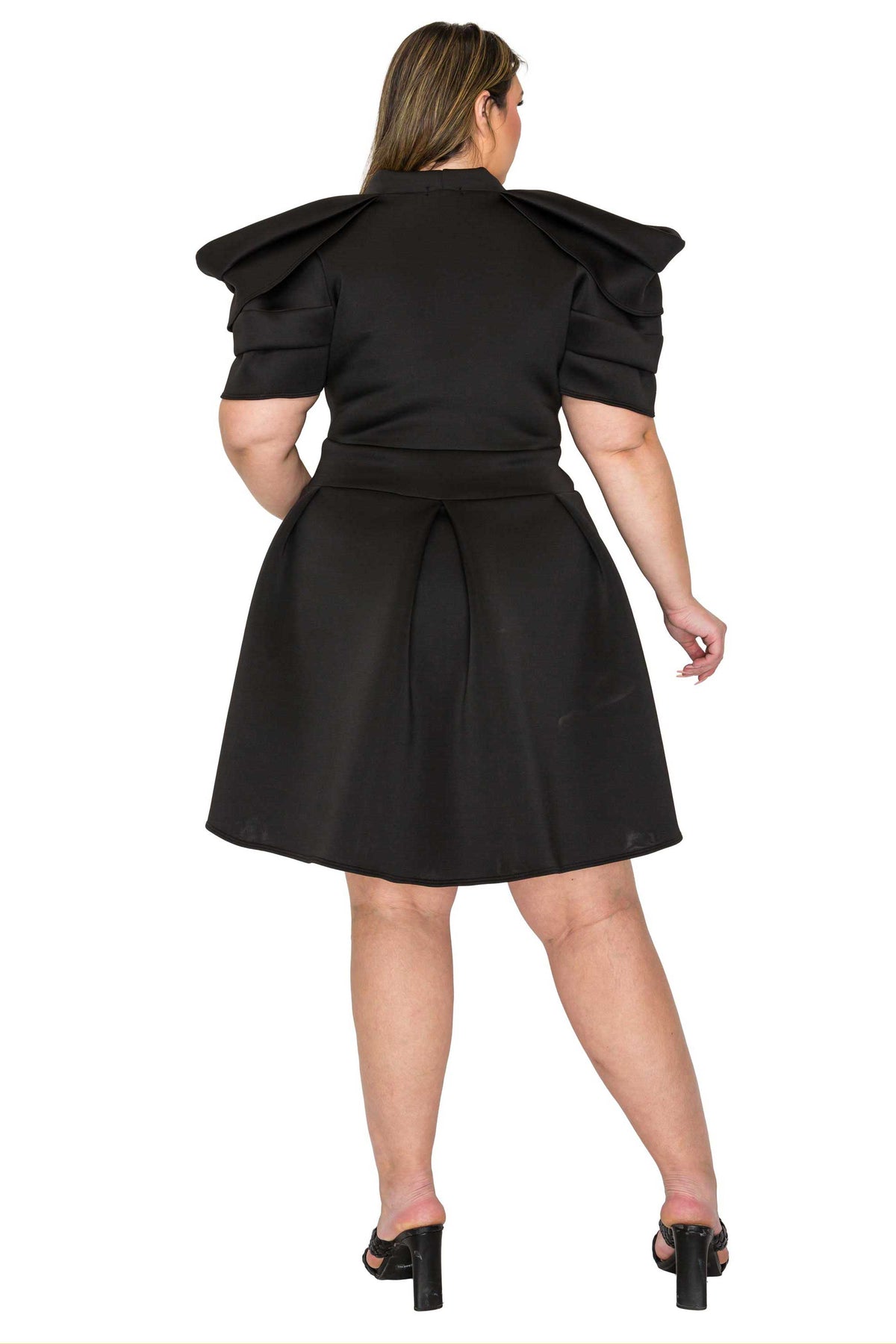 black color plus size neoprene party dress, statement shoulder, short flare hem. back view
