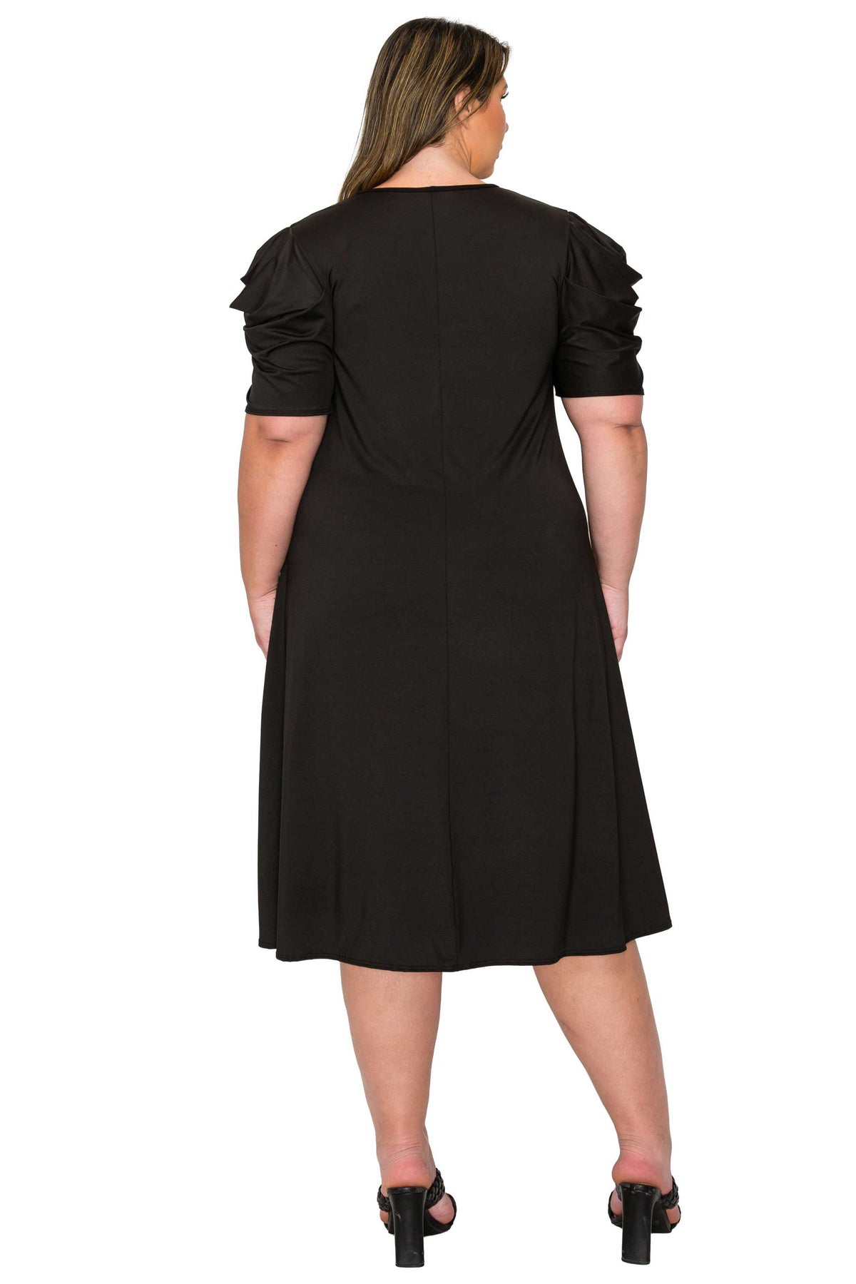black color plus size dress, back view of model. gathered shoulders and midi flare hem