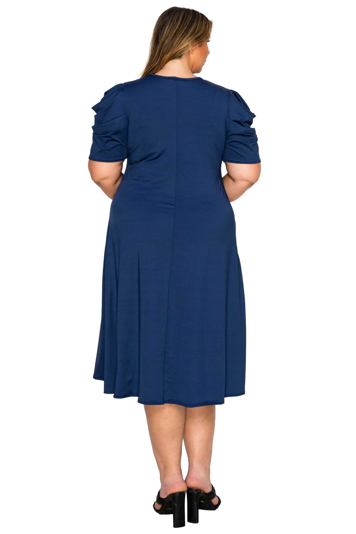 navy color plus size dress, back view of model. gathered shoulders and midi flare hem