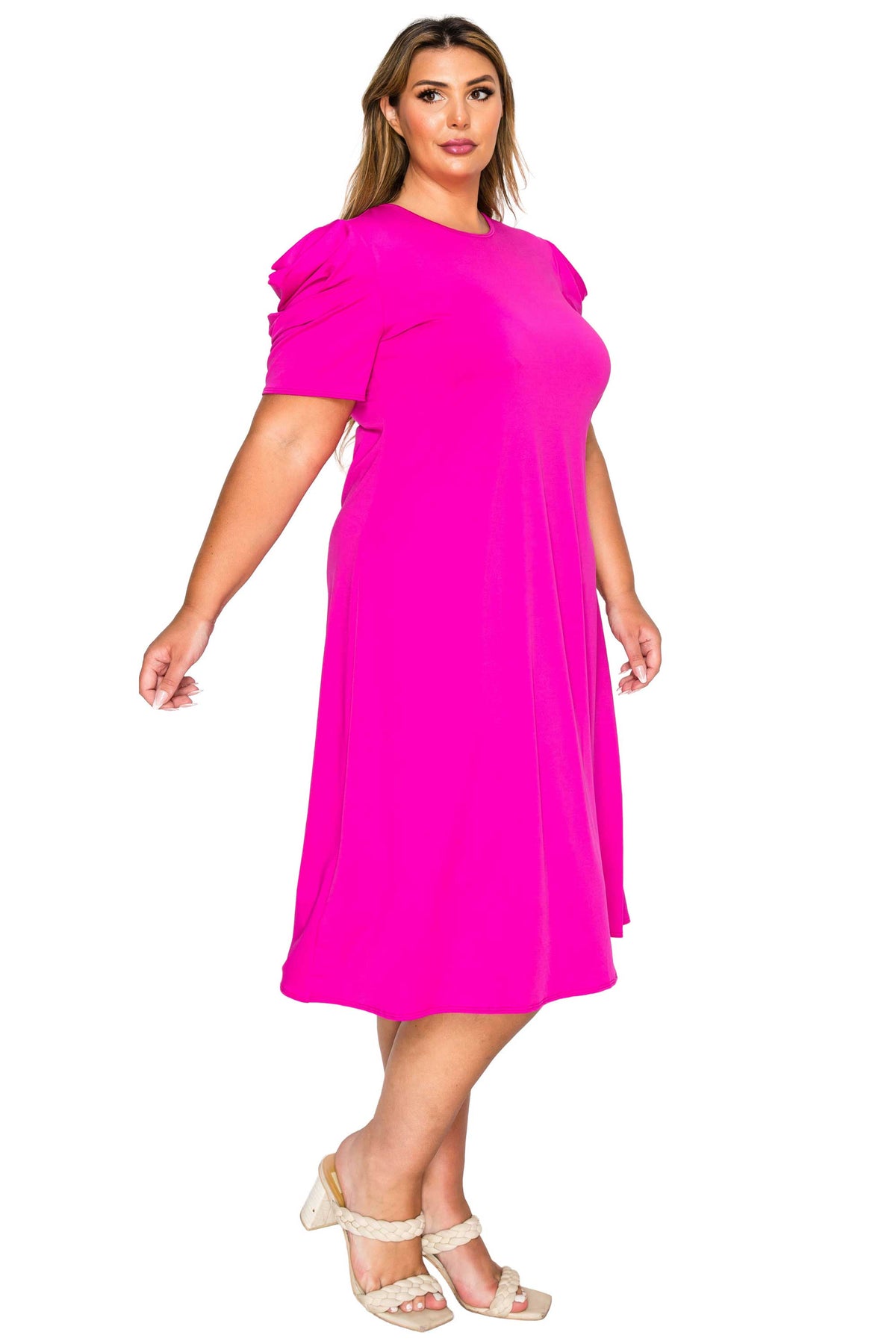 pink color plus size dress, side view of model. gathered shoulders and midi flare hem